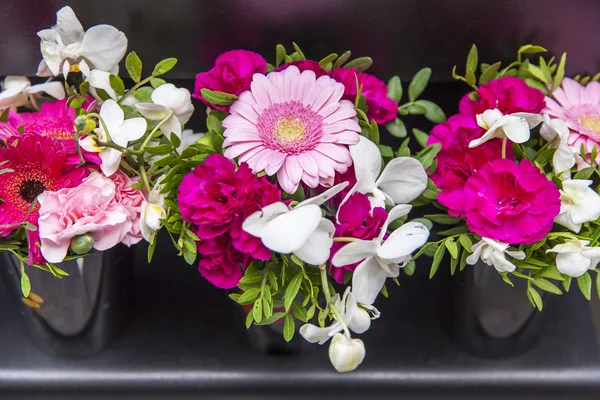 Beautiful bouquets of various flowers on a counter of shop — Stock Photo, Image