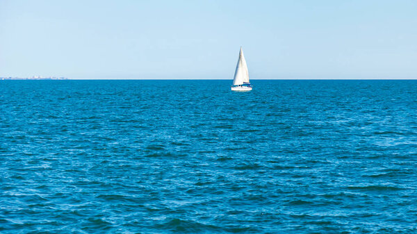 View of the sea distance. Sailboat on the horizon