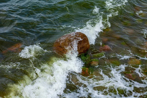 Sea wave and wet stones, natural background