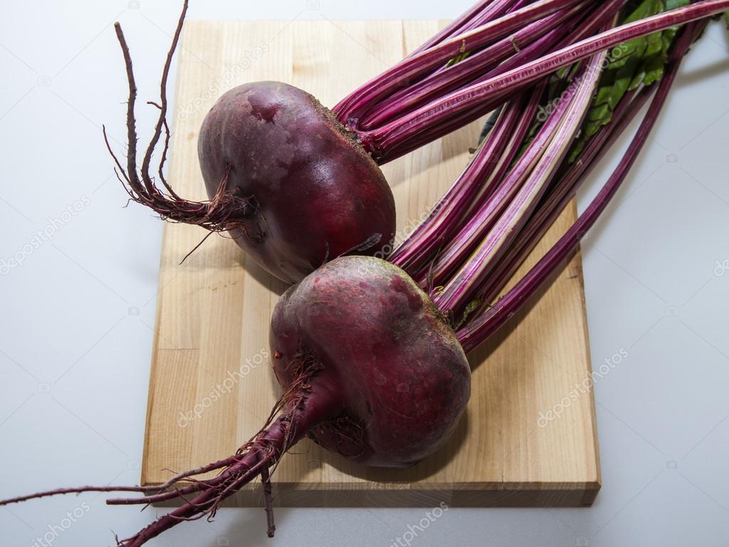 Two large fresh beets on a table