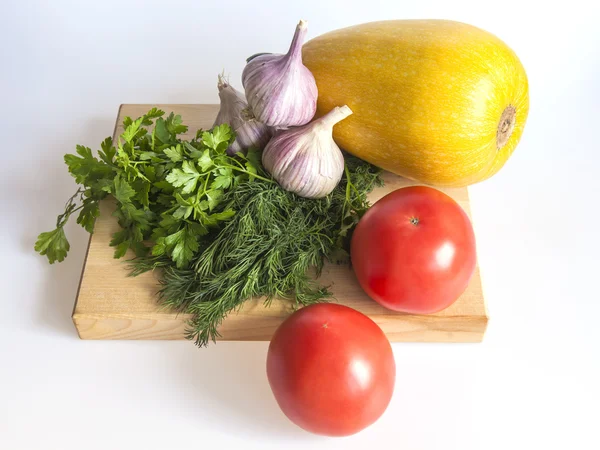 Orange pumpkin, tomato, greens and garlic for salad — Stock Photo, Image