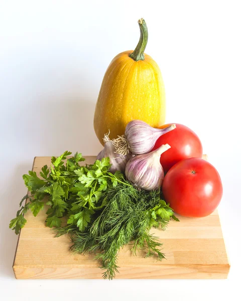 Orange pumpkin, tomato, greens and garlic for salad — Stock Photo, Image