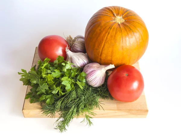 Orange pumpkin, tomato, greens and garlic for salad — Stock Photo, Image