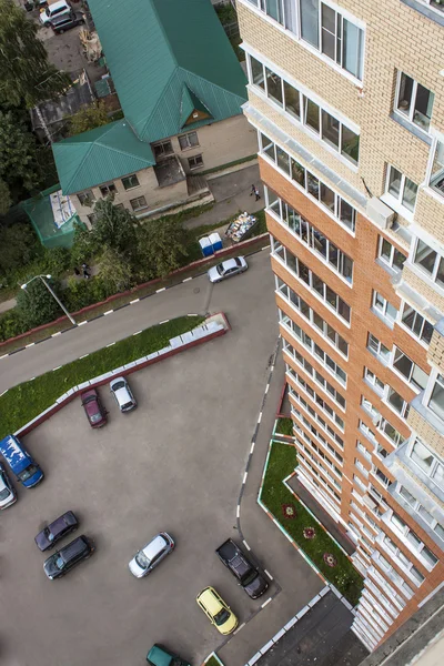 Pushkino, Ryssland, på Augusti 26, 2011. Utsikt från fönstret i flera våningar byggnaden. En parkering av bilar nära huset — Stockfoto