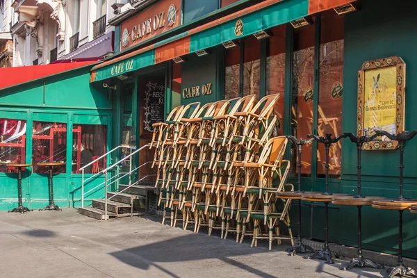 Typical urban view in the early spring morning. Piles of chairs of summer cafe before opening — Stock Photo, Image