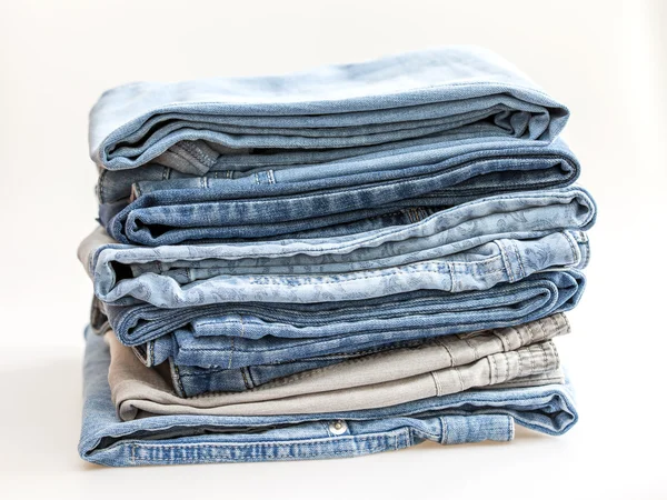 Pile of jeans of various shades — Stock Photo, Image