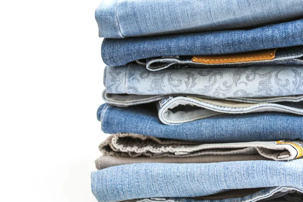 The different blue jeans folded by a pile — Stock Photo, Image