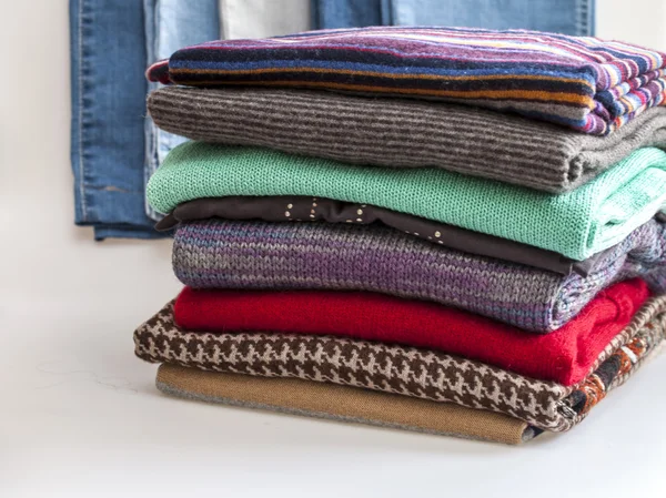 Pile of woolen jumpers of various colors and textures — Stock Photo, Image