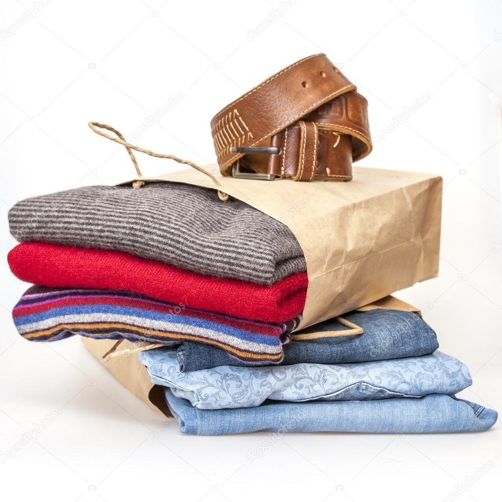 Shopping: a woolen jumper and jeans of various shades in paper packages