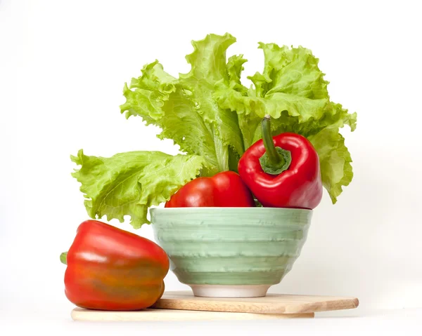 Large red paprika and bunch of fresh salad — Stock Photo, Image