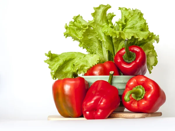 Large red paprika and bunch of fresh salad — Stock Photo, Image