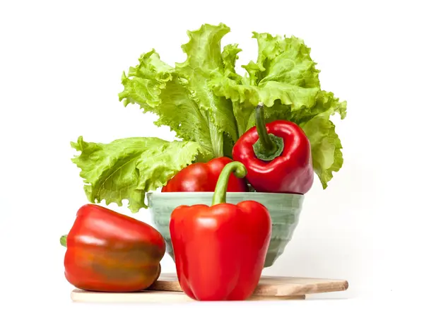 Large red paprika and bunch of fresh salad — Stock Photo, Image