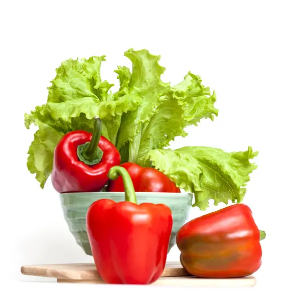 Large red paprika and bunch of fresh salad — Stock Photo, Image