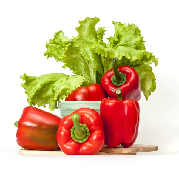 Large red paprika and bunch of fresh salad — Stock Photo, Image