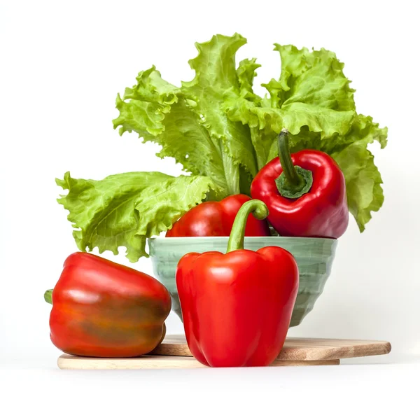 Large red paprika and bunch of fresh salad — Stock Photo, Image