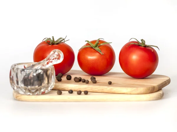 Red juicy tomatoes and black pepper — Stock Photo, Image