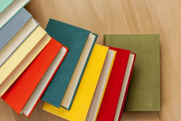 Vintage books in multi-colored covers on a table — Stock Photo, Image