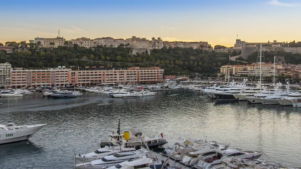 Principality of Monaco, France, on October 16, 2012. A view of the port and residential areas on a slope of mountains at sunset — Stock Photo, Image