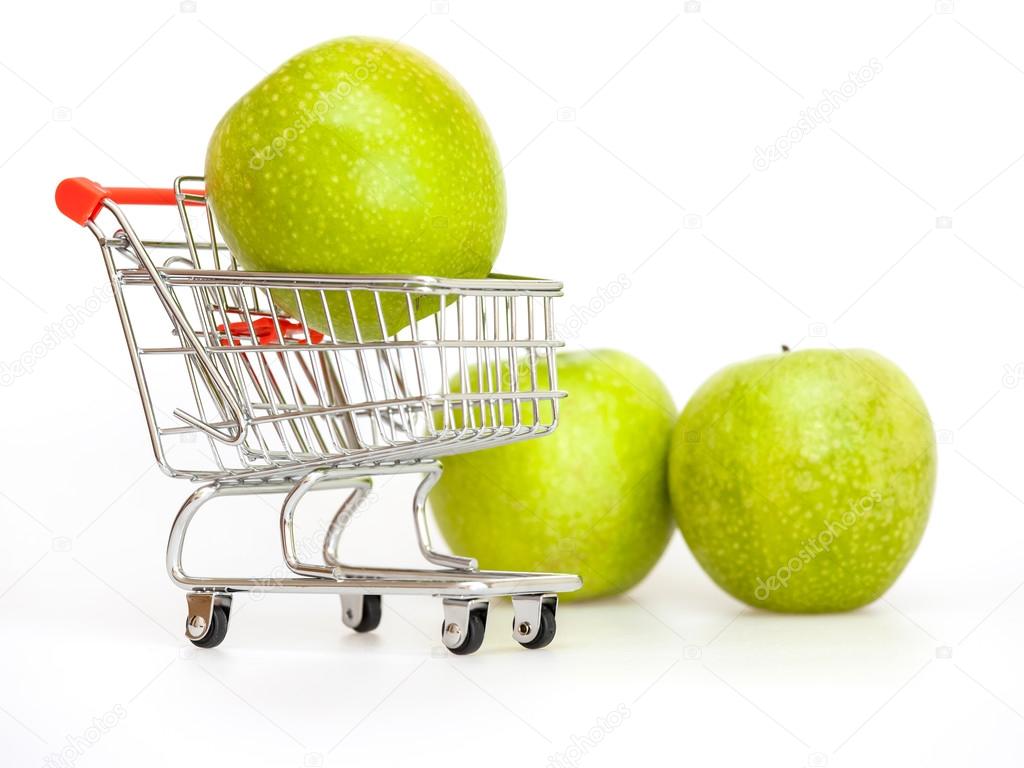 Large green apples in the cart for shopping