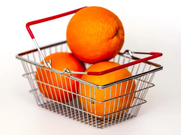 Bright large oranges in a basket for shopping — Stock Photo, Image