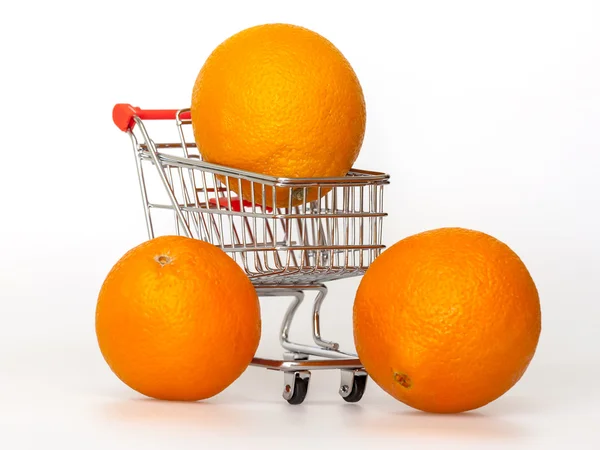 Large bright oranges in the cart for shopping — Stock Photo, Image