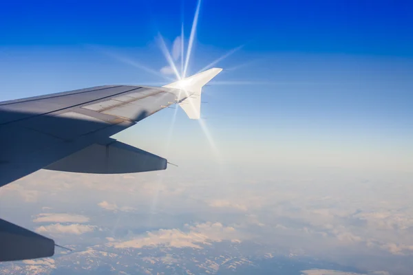 View of a wing of the plane and cloud from a window of the flying plane — Stock Photo, Image