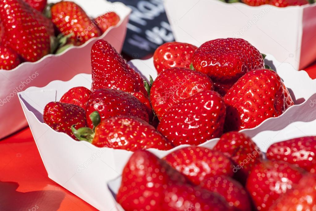 Fresh ripe strawberry on a market counter