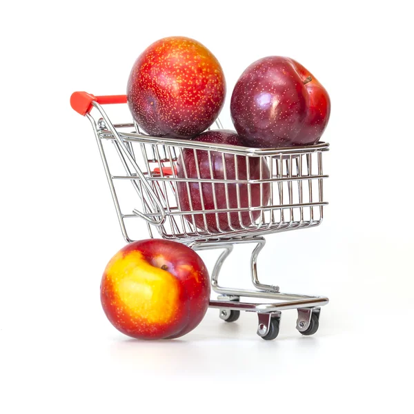 Large red plums in the store cart — Stock Photo, Image