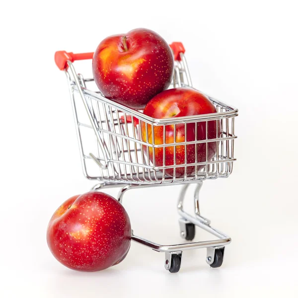 Large red plums in the store cart — Stock Photo, Image