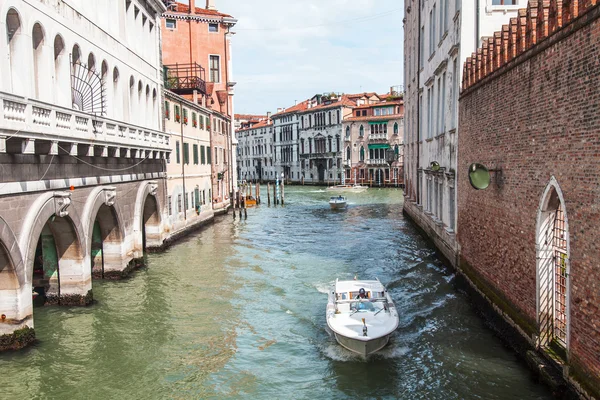 VENICE, ITALY - on APRIL 29, 2015. Boats of different function float on the typical street canal. The boat is the main vehicle in island part of the city — Stock Photo, Image