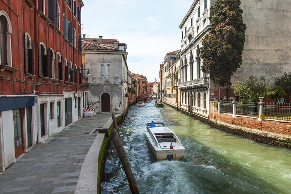 VENICE, ITALY - on APRIL 29, 2015. Boats of different function float on the typical street canal. The boat is the main vehicle in island part of the city — Stock Photo, Image