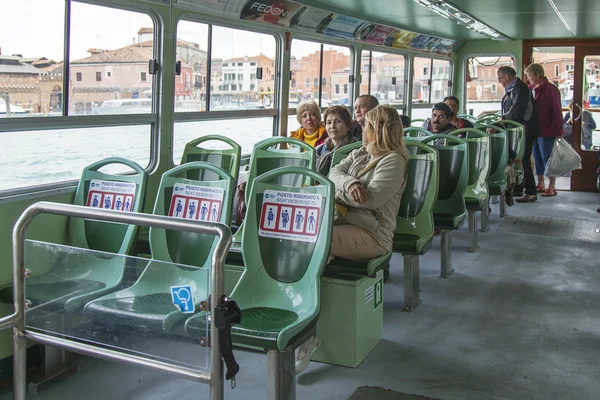 VENICE, ITALY - on APRIL 30, 2015. Passengers sit in salon вапоретто. Vaporetto - public transport in island part of Venice — Stock fotografie