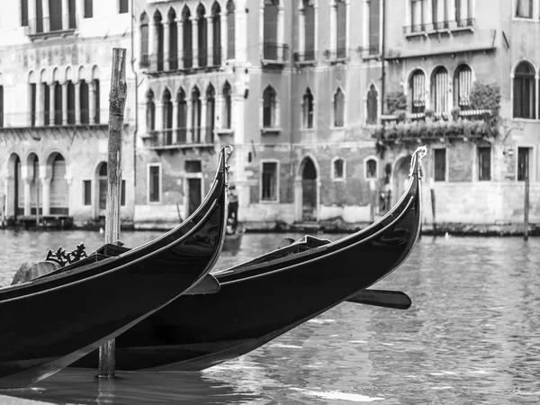 VENICE, ITALY - on APRIL 29, 2015. Two gondolas are moored at Grand kanal (Canal Grande) Embankment. — Stock Photo, Image