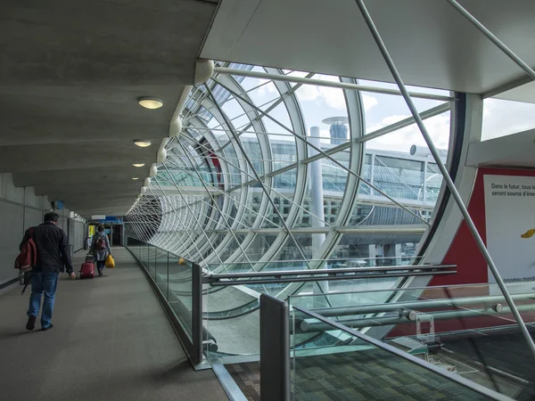 PARIS, FRANCE - on MAY 5, 2015. The international airport Charles de Gaulle, passengers go from the plane on glazed on gallery to the hall of an arrival.