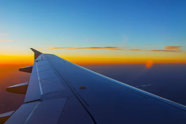 Plan vy från fönstret på solnedgång himlen — Stockfoto