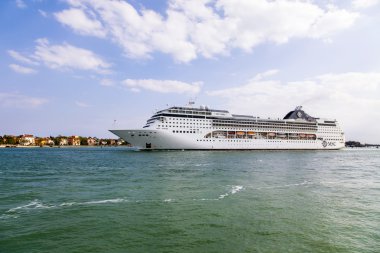 VENICE, ITALY - on MAY 1, 2015. The cruise ship Opera leaves seaport of Venice and passes by Lido's island