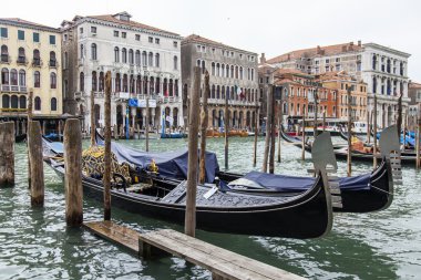 VENICE, ITALY - on MAY 3, 2015. The mooring of gondolas at pier on the bank of the Grand channel (Canal Grande).
