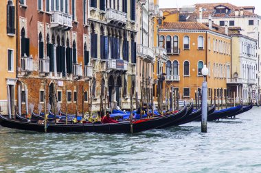 VENICE, ITALY - on MAY 4, 2015. Gondolas are moored about the coast of the channel. Ancient palaces on the embankment