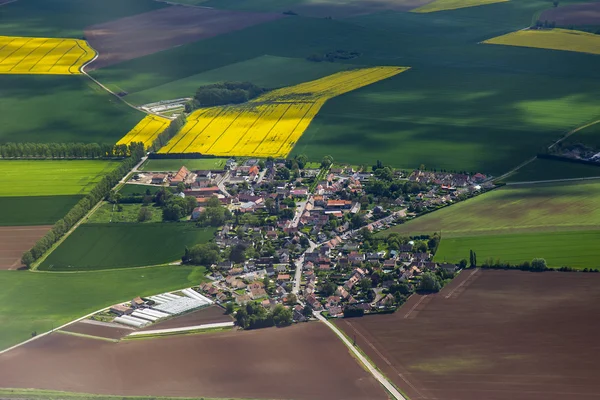 The top view from a window of the flying plane on the city and its vicinities