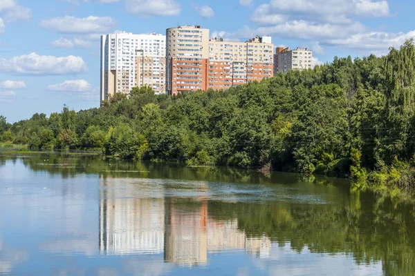 PUSHKINO, RUSIA, 11 de agosto de 2015. Día de verano brillante. Casas de varios pisos y parque en la orilla del río Serebryanka —  Fotos de Stock