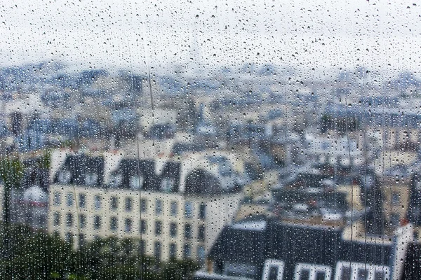 Paris, Frankrike, den 29 September 2015. Parisiska landskap. Utsikt över stadens tak genom en våt fönster under ett regn — Stockfoto