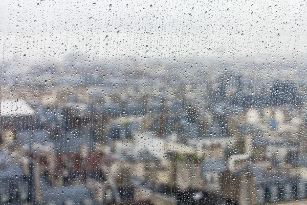 PARIS, FRANCE, le 31 août 2015. La vue du dessus depuis une plateforme d'arpentage sur les toits de Paris à travers du verre mouillé sous une pluie — Photo