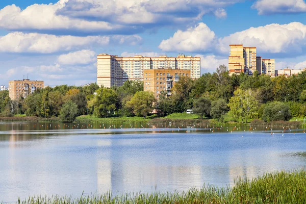 PUSHKINO, RUSSIA, on SEPTEMBER 15, 2015. City autumn landscape. Houses on the river bank of Serebryank