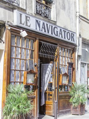 PARIS, FRANCE, on AUGUST 28, 2015. Urban view. Typical Parisian street in the bright sunny day. Entrance into cafe