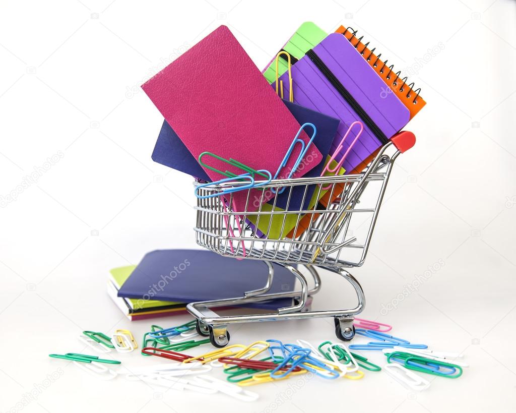 Notebooks of various colors in the cart for shopping