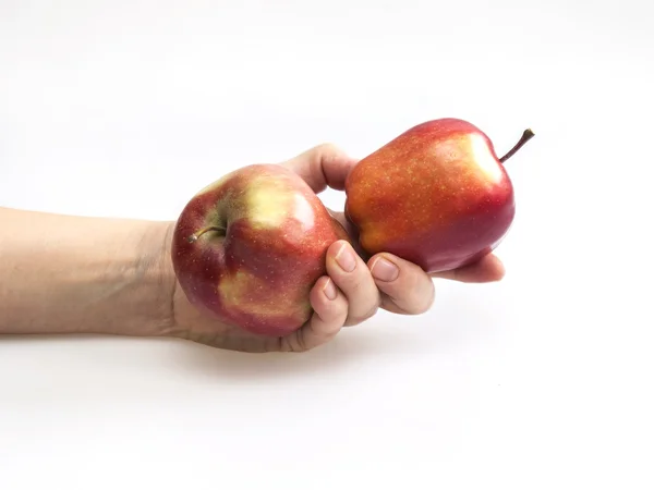 Zwei rote Äpfel in einer Hand — Stockfoto