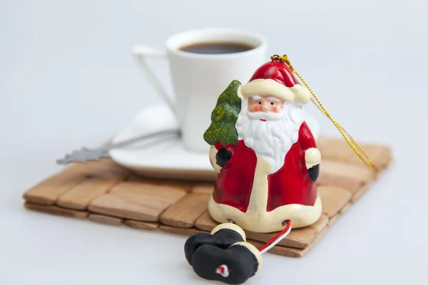 Cup with black coffee and Father Frost's figure — Stock Photo, Image