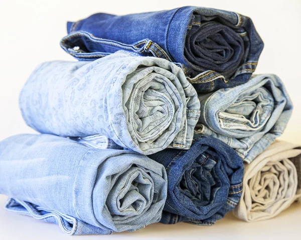 The jeans curtailed in a roll on a counter of shop — Stock Photo, Image