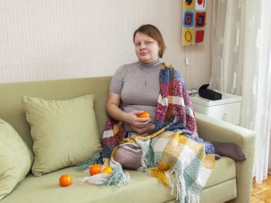 Kadın bir kanepe odasında oturur