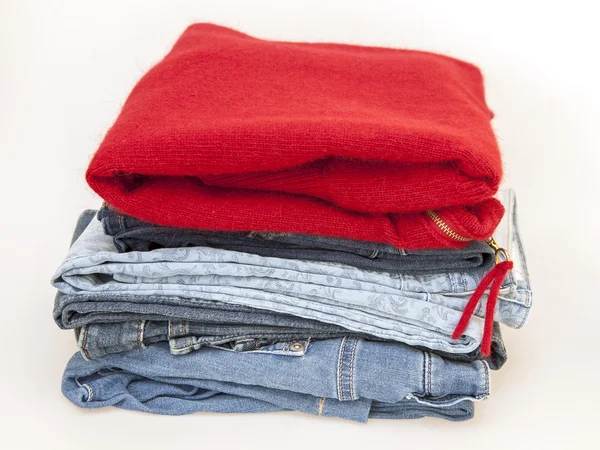Red jumper and jeans on a counter of shop — Stock Photo, Image